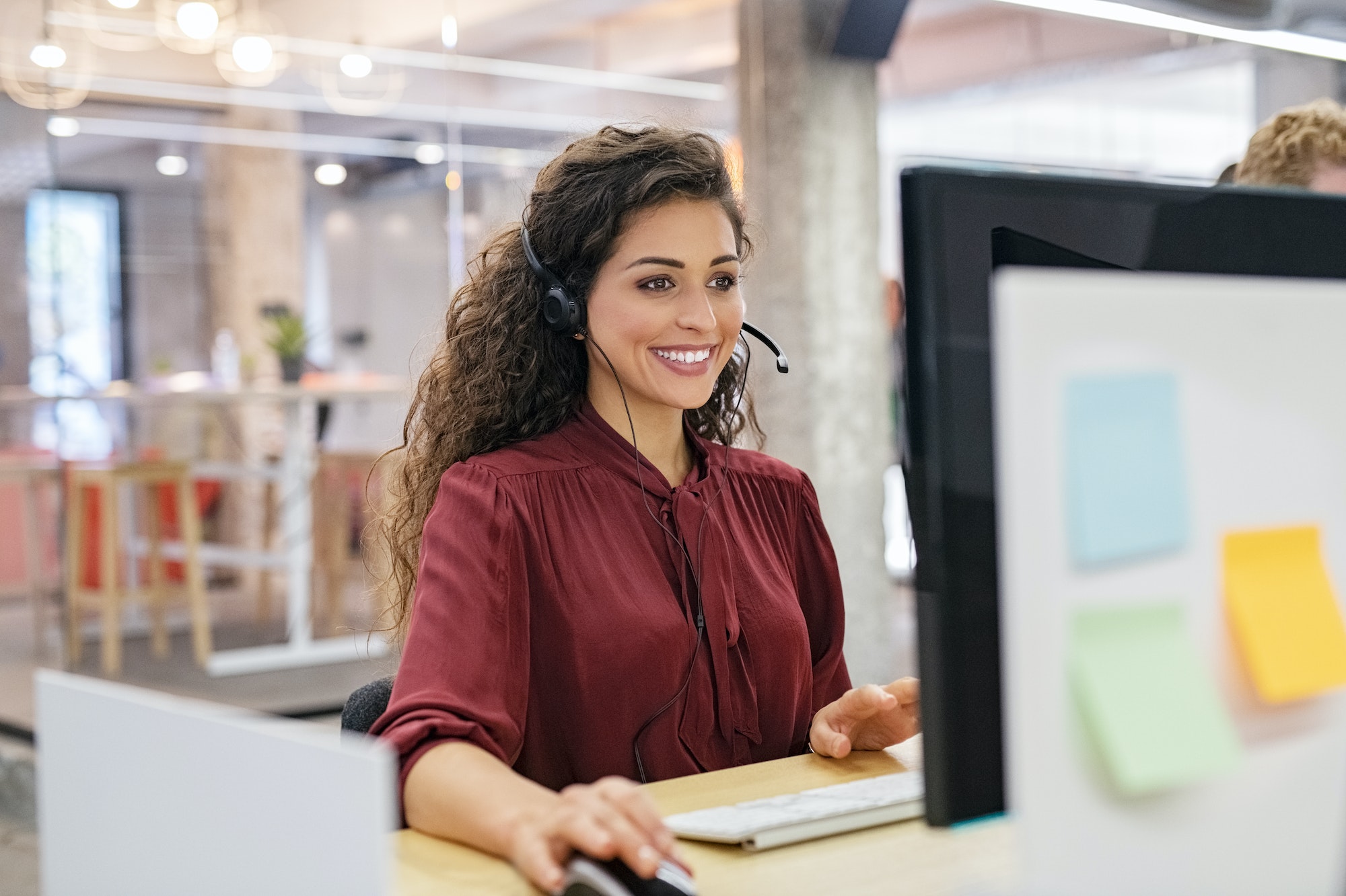 Happy smiling woman working in call center-letsworkabroad